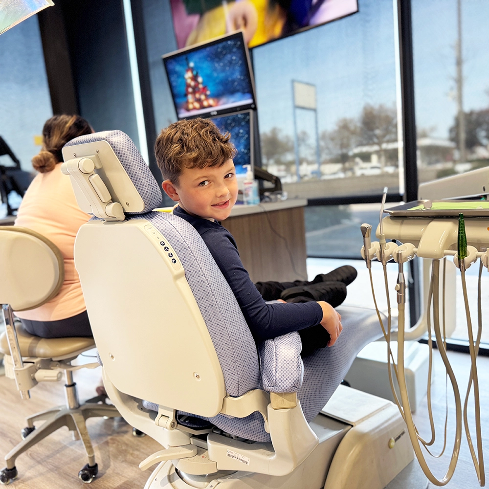 Child holding a balloon in a dentists office